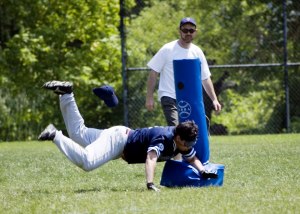 Joe Q diving into a base during a beep ball game.