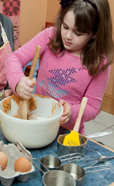 Image of a child baking cookies