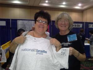 oanne and a friend hold up a NBP t-shirt at the 2014 ACB Convention