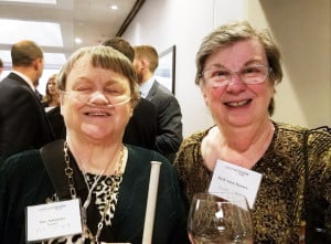 Photo of Sue and Ruth Ann Hansen wearing nametags and smiling at the camera