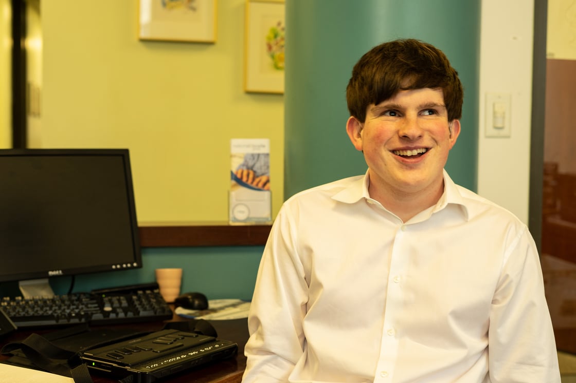 Jack and his braille display at the National Braille Press front desk