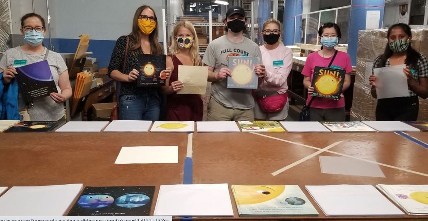 A Group of People Making A Difference Volunteers, masked up at NBP to help collate copies of "Sun, One in a Million.'