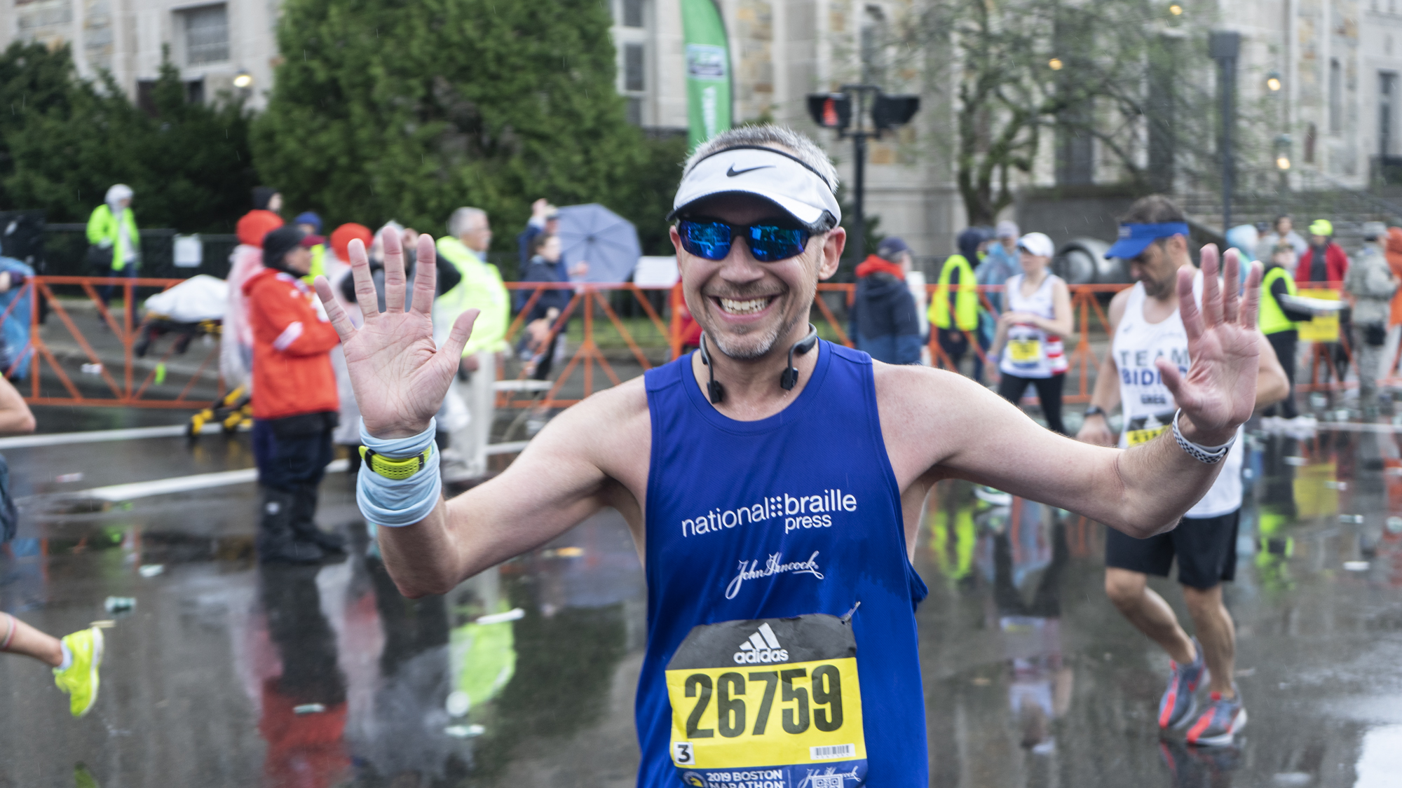 William Flynn smiling for the camera at mile 24 during the 2019 Boston Marathon