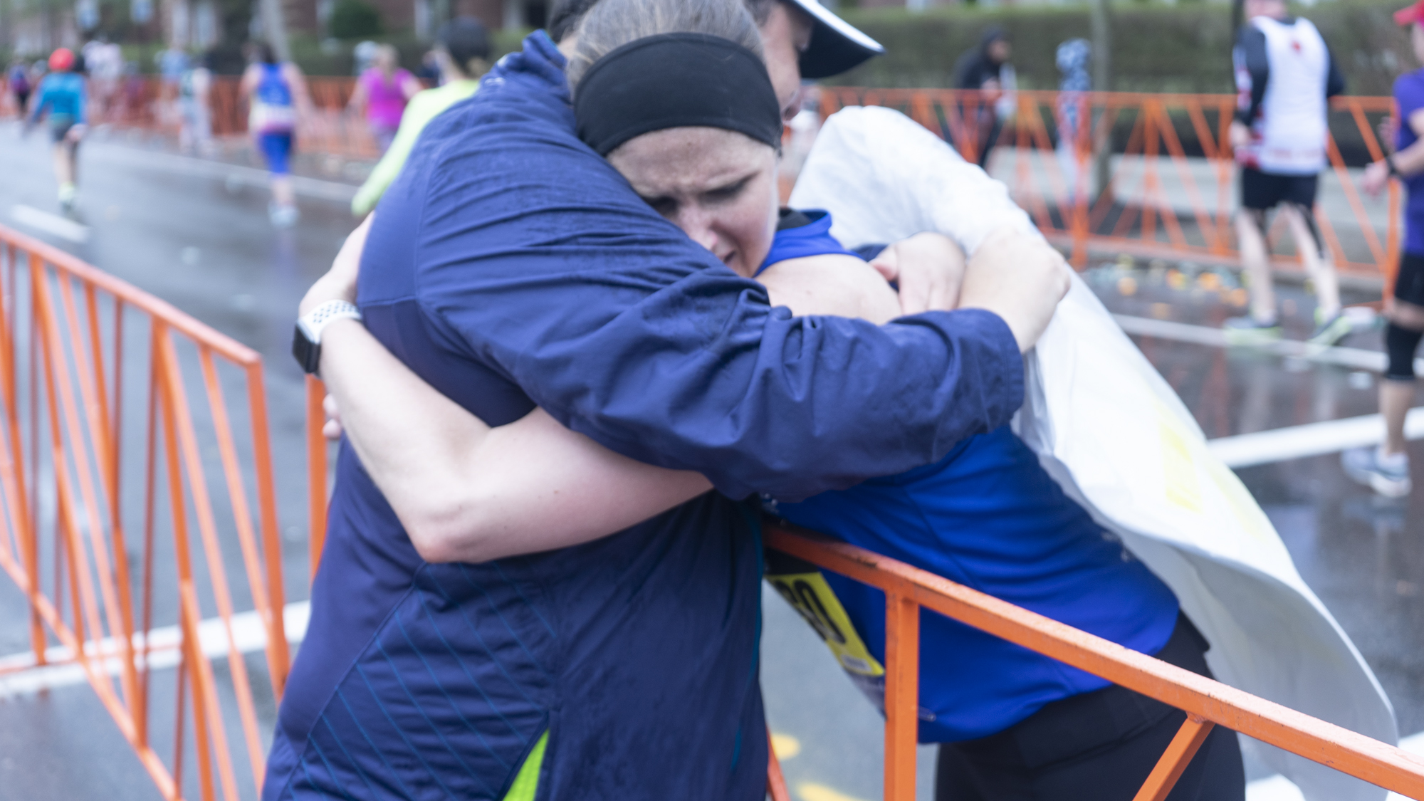 Erin Connors hugging NBP's VP of Development, Joe Quintanilla at mile 24 of the Boston Marathon.